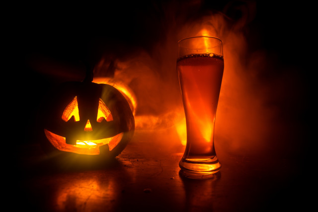 A jack-o-lantern and a beer