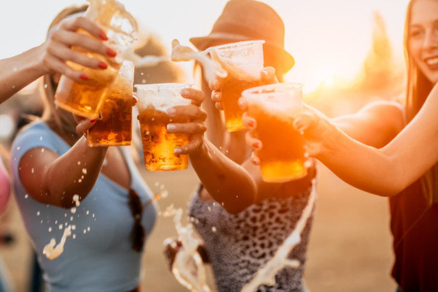 Female friends toasting with beer