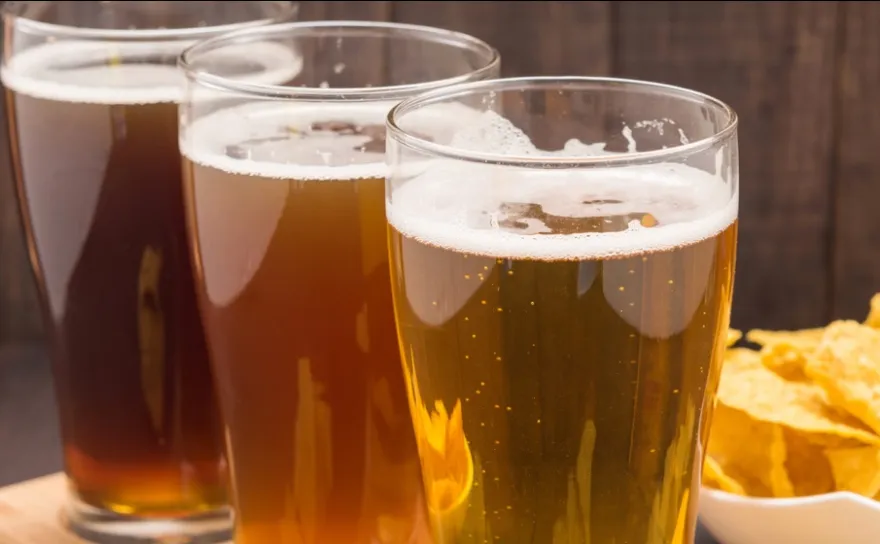 Three Mexican-style lagers with chips in background