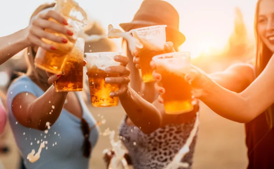 Female friends toasting with beer