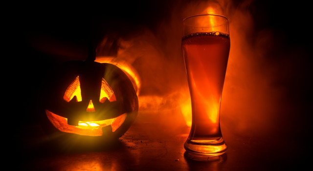 A jack-o-lantern and a beer